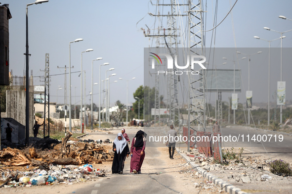 Displaced Palestinians, who are fleeing north Gaza after being ordered by the Israeli army to move southward amid the Israel-Hamas conflict,...