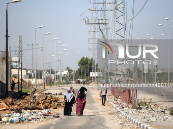 Displaced Palestinians, who are fleeing north Gaza after being ordered by the Israeli army to move southward amid the Israel-Hamas conflict,...