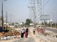 Displaced Palestinians, who are fleeing north Gaza after being ordered by the Israeli army to move southward amid the Israel-Hamas conflict,...