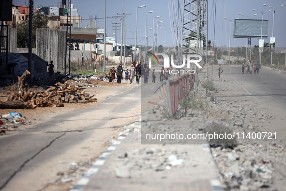 Displaced Palestinians, who are fleeing north Gaza after being ordered by the Israeli army to move southward amid the Israel-Hamas conflict,...