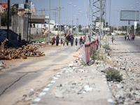 Displaced Palestinians, who are fleeing north Gaza after being ordered by the Israeli army to move southward amid the Israel-Hamas conflict,...