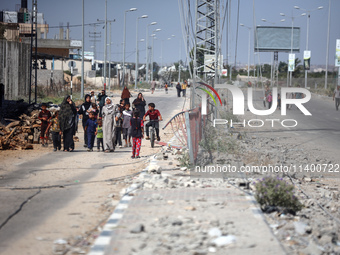 Displaced Palestinians, who are fleeing north Gaza after being ordered by the Israeli army to move southward amid the Israel-Hamas conflict,...