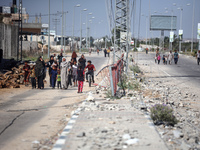 Displaced Palestinians, who are fleeing north Gaza after being ordered by the Israeli army to move southward amid the Israel-Hamas conflict,...