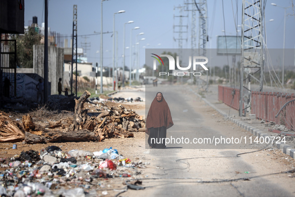 Displaced Palestinians, who are fleeing north Gaza after being ordered by the Israeli army to move southward amid the Israel-Hamas conflict,...