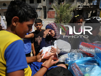 Displaced Palestinians, who are fleeing north Gaza after being ordered by the Israeli army to move southward amid the Israel-Hamas conflict,...