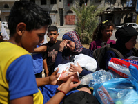 Displaced Palestinians, who are fleeing north Gaza after being ordered by the Israeli army to move southward amid the Israel-Hamas conflict,...