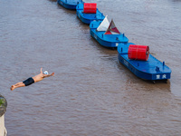 A citizen is jumping into the Yangtze River for a swim after the water level rose sharply in Chongqing, China, on July 11, 2024. It is repor...