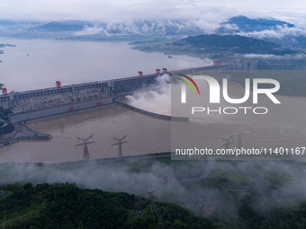 The Three Gorges Dam is opening three holes to release flood water at sunset in Yichang, Hubei province, China, on July 11, 2024. (