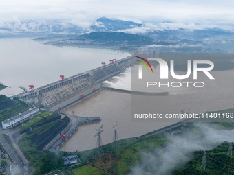 The Three Gorges Dam is opening three holes to release flood water at sunset in Yichang, Hubei province, China, on July 11, 2024. (