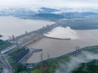 The Three Gorges Dam is opening three holes to release flood water at sunset in Yichang, Hubei province, China, on July 11, 2024. (