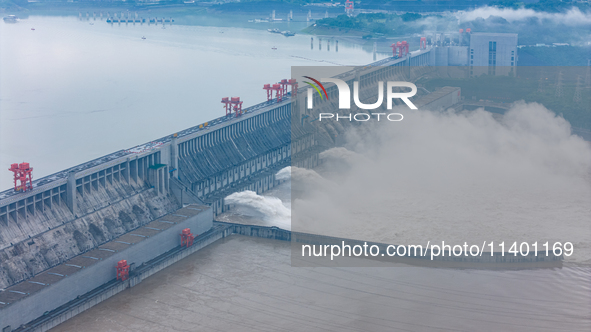 The Three Gorges Dam is opening three holes to release flood water at sunset in Yichang, Hubei province, China, on July 11, 2024. 