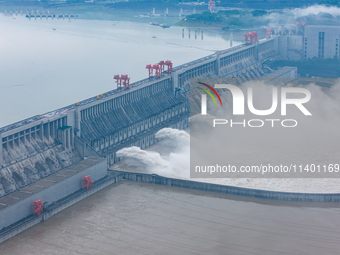 The Three Gorges Dam is opening three holes to release flood water at sunset in Yichang, Hubei province, China, on July 11, 2024. (