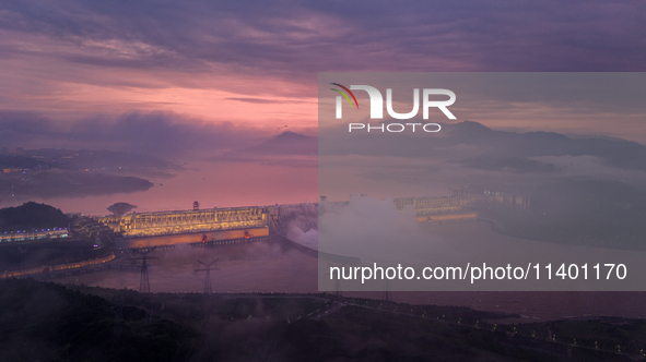 The Three Gorges Dam is opening three holes to release flood water at sunset in Yichang, Hubei province, China, on July 11, 2024. 