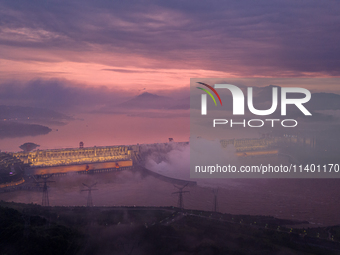 The Three Gorges Dam is opening three holes to release flood water at sunset in Yichang, Hubei province, China, on July 11, 2024. (