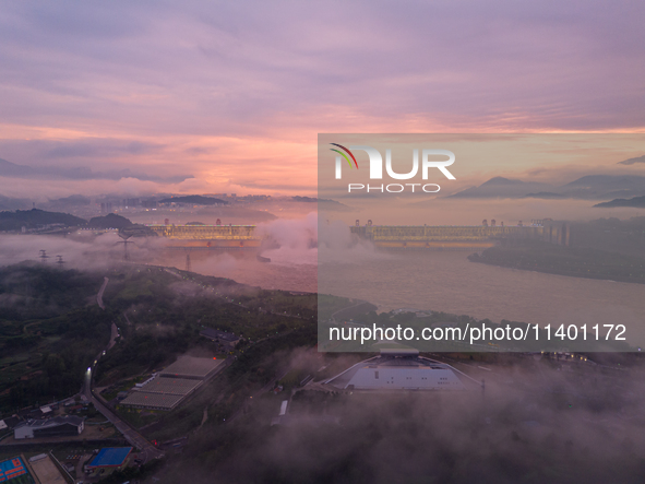 The Three Gorges Dam is opening three holes to release flood water at sunset in Yichang, Hubei province, China, on July 11, 2024. 