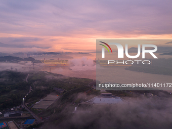 The Three Gorges Dam is opening three holes to release flood water at sunset in Yichang, Hubei province, China, on July 11, 2024. (