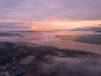 The Three Gorges Dam is opening three holes to release flood water at sunset in Yichang, Hubei province, China, on July 11, 2024. (