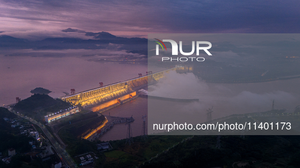 The Three Gorges Dam is opening three holes to release flood water at sunset in Yichang, Hubei province, China, on July 11, 2024. 