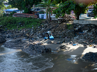 A scavenger is collecting plastic bottle waste at Padang Beach in Padang City, West Sumatra, Indonesia, on July 11, 2024. The lack of awaren...