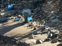 A scavenger is collecting plastic bottle waste at Padang Beach in Padang City, West Sumatra, Indonesia, on July 11, 2024. The lack of awaren...