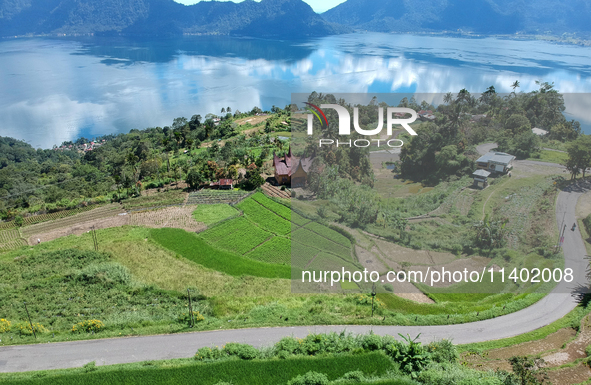 An aerial view is showing Lake Maninjau in Agam Regency, West Sumatra, Indonesia, on July 11, 2024. The Maninjau caldera is being formed by...