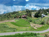 An aerial view is showing Lake Maninjau in Agam Regency, West Sumatra, Indonesia, on July 11, 2024. The Maninjau caldera is being formed by...