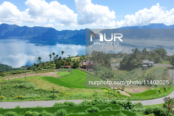 An aerial view is showing Lake Maninjau in Agam Regency, West Sumatra, Indonesia, on July 11, 2024. The Maninjau caldera is being formed by...