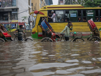 Vehicles are getting stuck on a waterlogged street after heavy rain in Dhaka, Bangladesh, on July 12, 2024. (