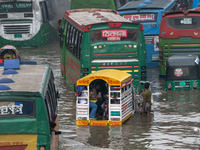 Vehicles are getting stuck on a waterlogged street after heavy rain in Dhaka, Bangladesh, on July 12, 2024. (