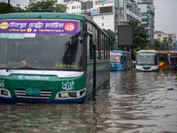 Vehicles are getting stuck on a waterlogged street after heavy rain in Dhaka, Bangladesh, on July 12, 2024. (