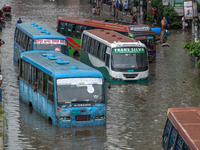 Vehicles are getting stuck on a waterlogged street after heavy rain in Dhaka, Bangladesh, on July 12, 2024. (