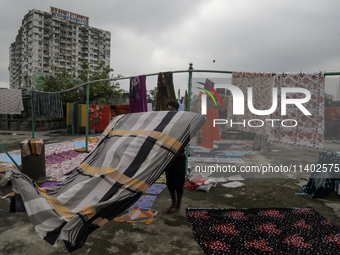 Street vendors are drying their goods on the roof of a market after it is waterlogged following a heavy downpour in Dhaka, Bangladesh, on Ju...