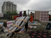 Street vendors are drying their goods on the roof of a market after it is waterlogged following a heavy downpour in Dhaka, Bangladesh, on Ju...