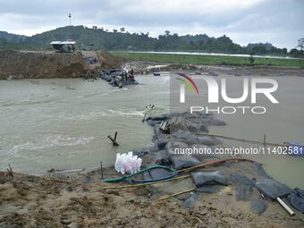 Dumping of Mega Geo bags is underway at the Hatimura embankment, constructed at the source of Kolong River in Koliabor, Nagaon District, Ass...