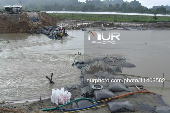 Dumping of Mega Geo bags is underway at the Hatimura embankment, constructed at the source of Kolong River in Koliabor, Nagaon District, Ass...