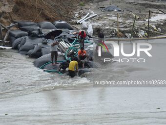 Dumping of Mega Geo bags is underway at the Hatimura embankment, constructed at the source of Kolong River in Koliabor, Nagaon District, Ass...