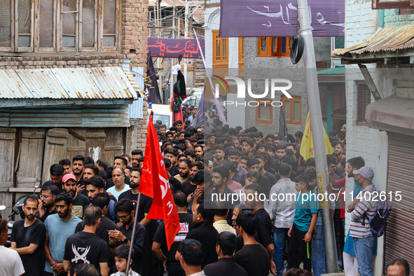 Shiite Muslim mourners are taking part in a Muharram procession on the fifth day of Ashura, in Srinagar, Jammu and Kashmir, on July 12, 2024...