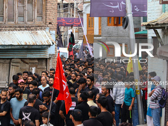 Shiite Muslim mourners are taking part in a Muharram procession on the fifth day of Ashura, in Srinagar, Jammu and Kashmir, on July 12, 2024...