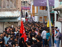 Shiite Muslim mourners are taking part in a Muharram procession on the fifth day of Ashura, in Srinagar, Jammu and Kashmir, on July 12, 2024...