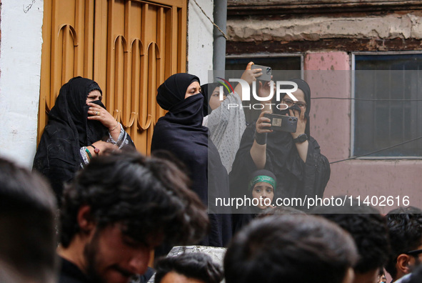 Kashmiri Shiite Muslims are watching a Muharram procession on the fifth day of Ashura, in Srinagar, Jammu and Kashmir, on July 12, 2024. 