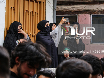 Kashmiri Shiite Muslims are watching a Muharram procession on the fifth day of Ashura, in Srinagar, Jammu and Kashmir, on July 12, 2024. (