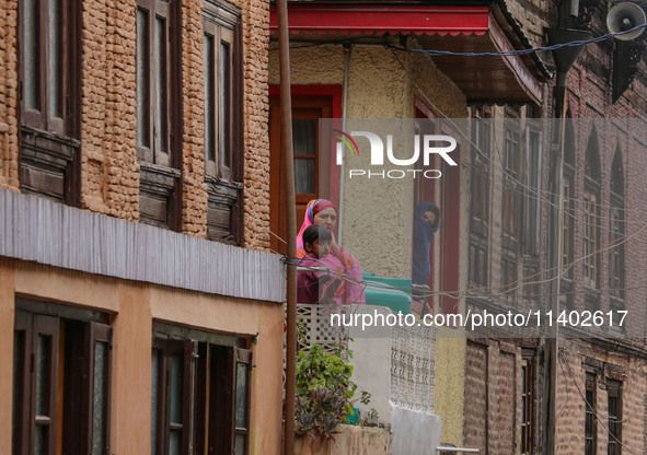 Kashmiri Muslims are watching a Muharram procession on the fifth day of Ashura, in Srinagar, Jammu and Kashmir, on July 12, 2024. 