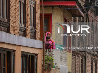 Kashmiri Muslims are watching a Muharram procession on the fifth day of Ashura, in Srinagar, Jammu and Kashmir, on July 12, 2024. (