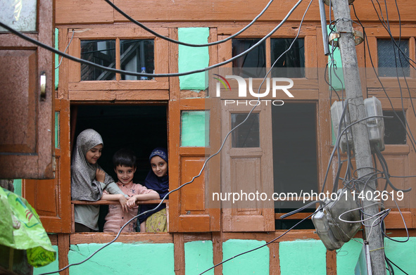 Children are watching a Muharram procession on the fifth day of Ashura, in Srinagar, Jammu and Kashmir, on July 12, 2024. 