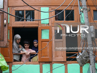 Children are watching a Muharram procession on the fifth day of Ashura, in Srinagar, Jammu and Kashmir, on July 12, 2024. (