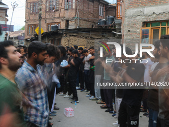 Shiite Muslim mourners are taking part in a Muharram procession on the fifth day of Ashura, in Srinagar, Jammu and Kashmir, on July 12, 2024...