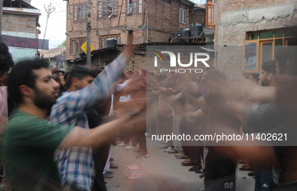 Shiite Muslim mourners are taking part in a Muharram procession on the fifth day of Ashura, in Srinagar, Jammu and Kashmir, on July 12, 2024...