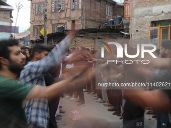 Shiite Muslim mourners are taking part in a Muharram procession on the fifth day of Ashura, in Srinagar, Jammu and Kashmir, on July 12, 2024...