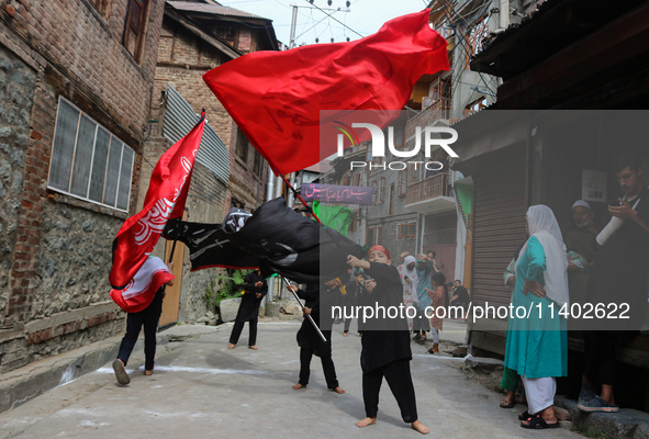 Kashmiri Shiite Muslim children are waving religious flags during a Muharram procession on the fifth day of Ashura, in Srinagar, Jammu and K...