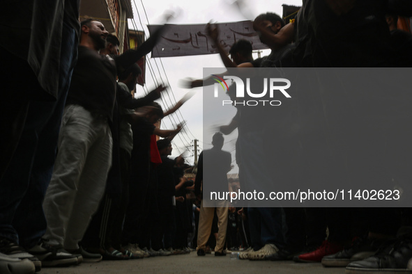 Shiite Muslim mourners are taking part in a Muharram procession on the fifth day of Ashura, in Srinagar, Jammu and Kashmir, on July 12, 2024...